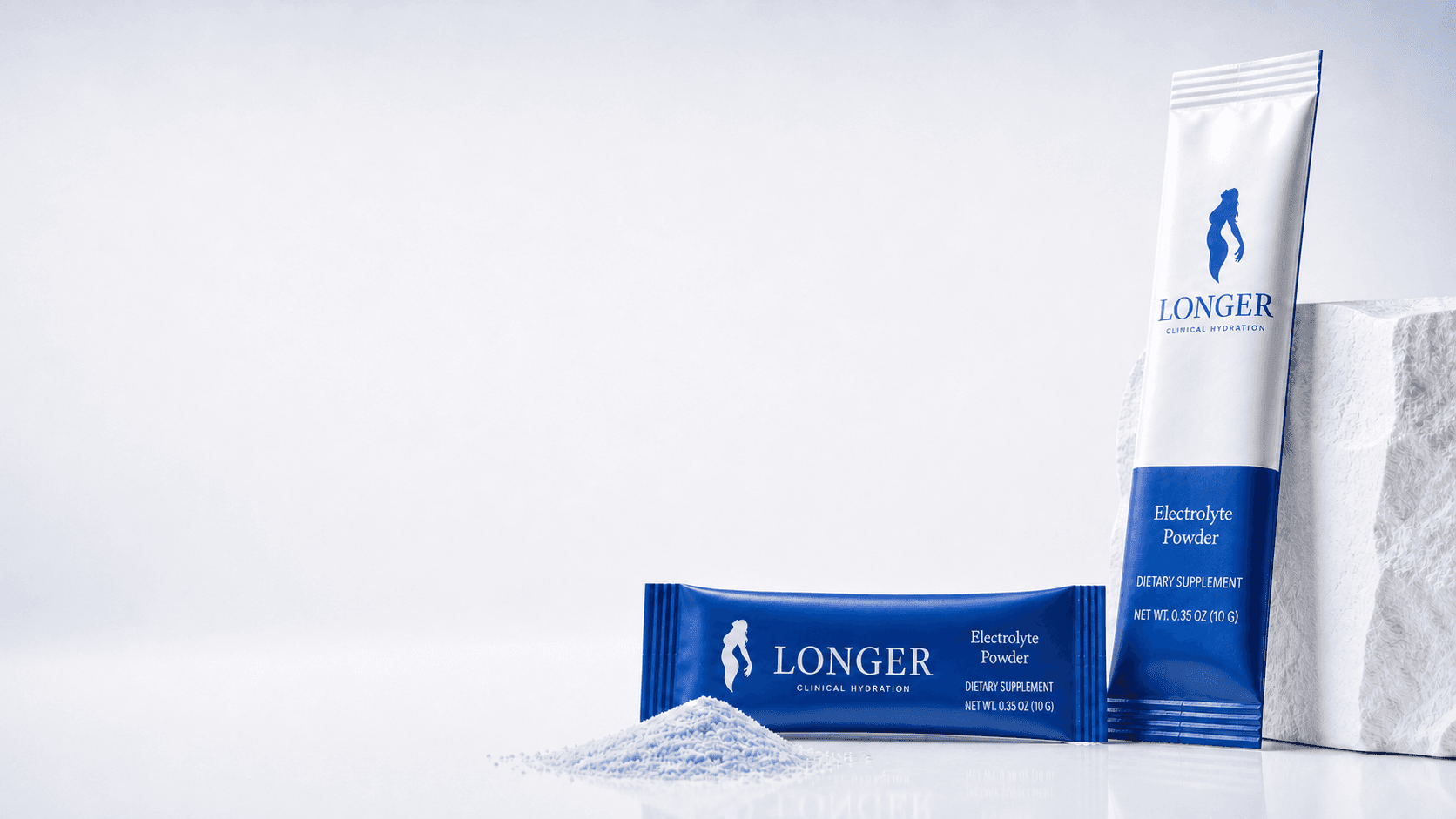 Longer performance hydration stick packs arranged beside a white clinical plinth